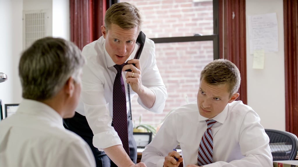 Hardy, Wolf and Downing attorneys in the firm office, one taking a phone call